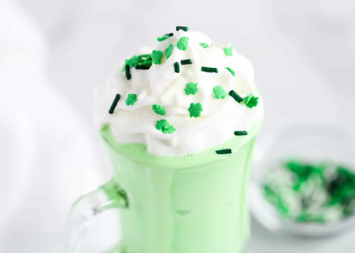 green shake with sprinkles and whipped cream on top