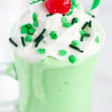 green shake with sprinkles and whipped cream on top