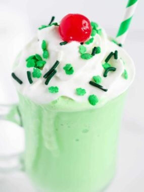 green shake with sprinkles and whipped cream on top
