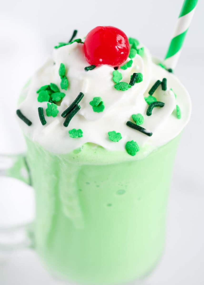 green shake with sprinkles and whipped cream on top