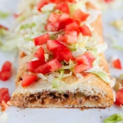 sliced taco braid with tomatoes and lettuce