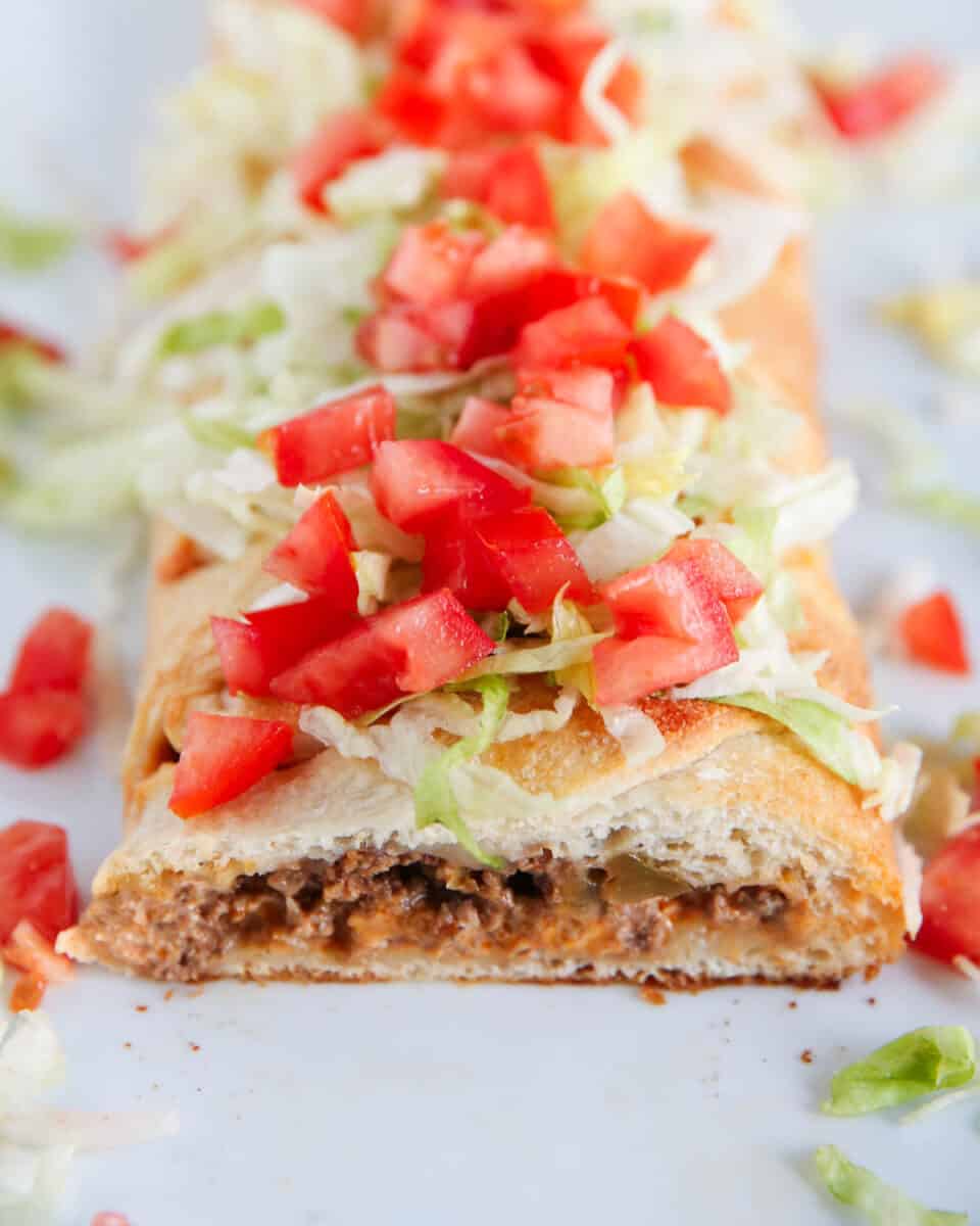 sliced taco braid with tomatoes and lettuce