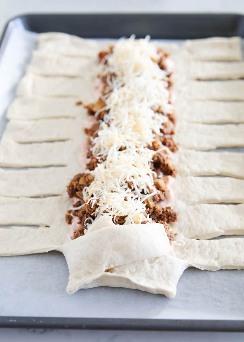 wrapping dough around taco meat to make taco braid