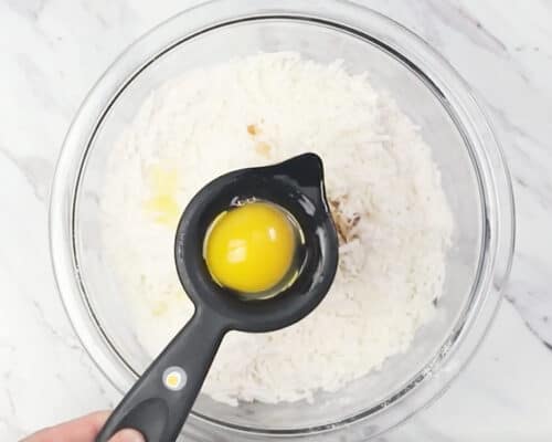 placing egg yolk in bowl