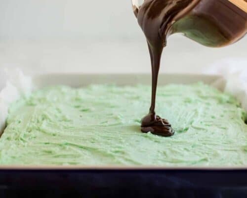 pouring chocolate over mint frosting