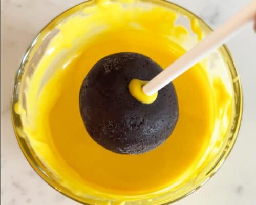 dipping cake pop in yellow chocolate
