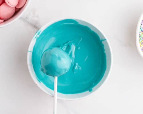 dipping cake balls in blue chocolate