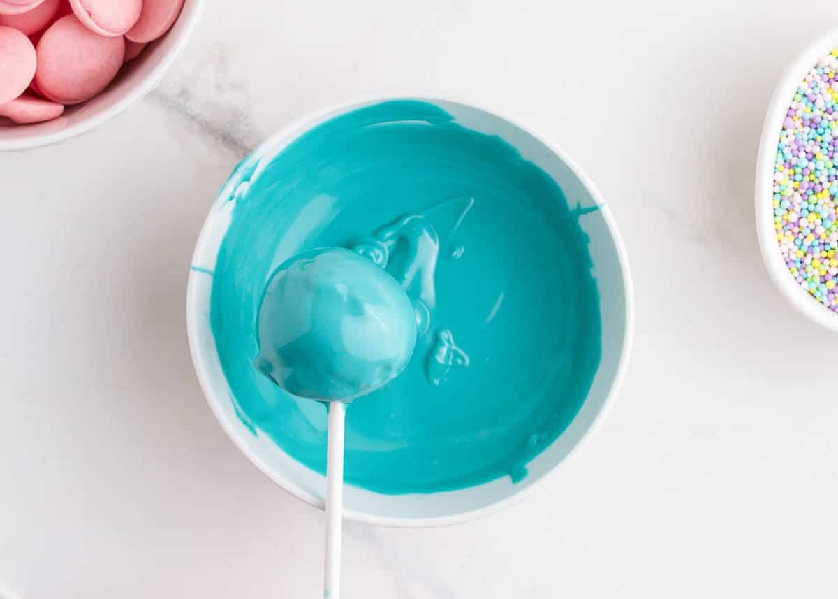 dipping cake balls in blue chocolate