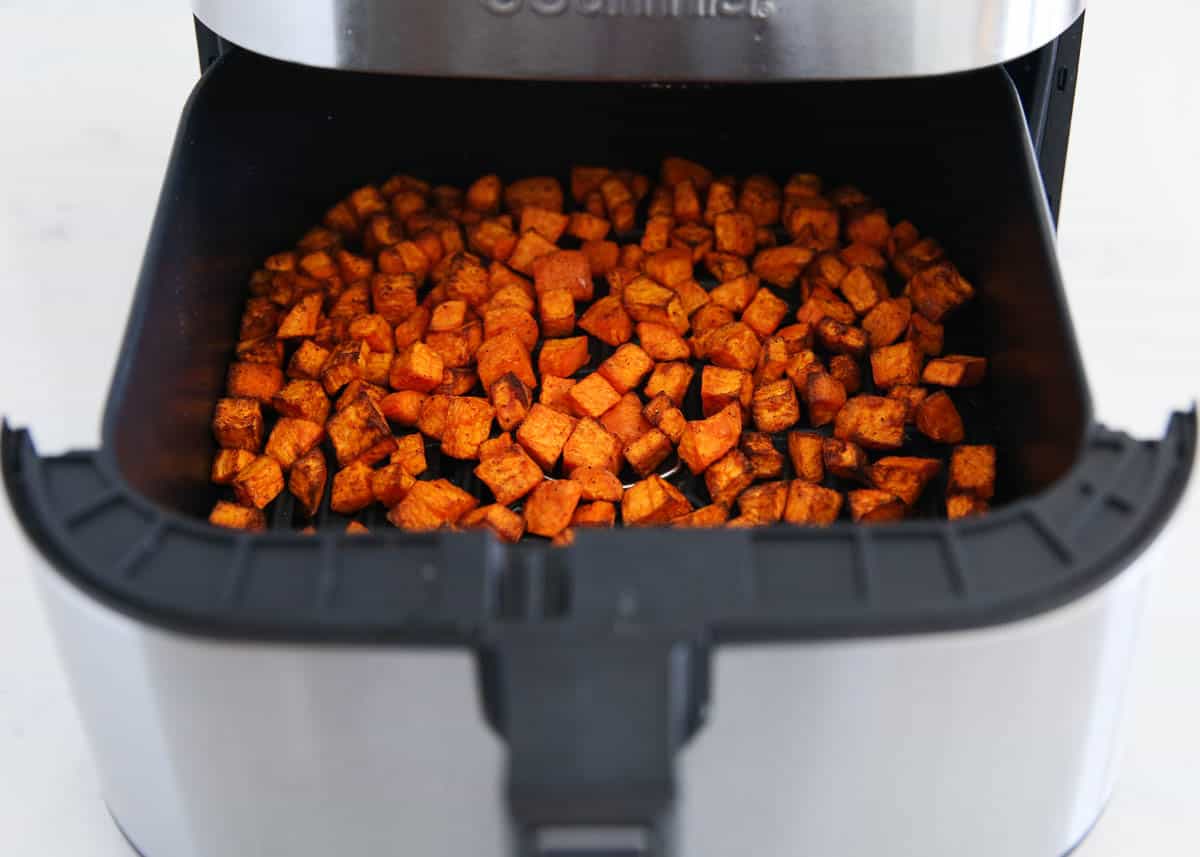 Sweet potato cubes in air fryer basket. 