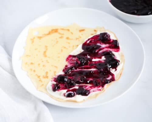 blueberry sauce on top of crepes