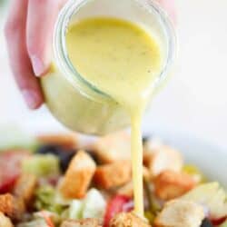 pouring dressing on top of salad