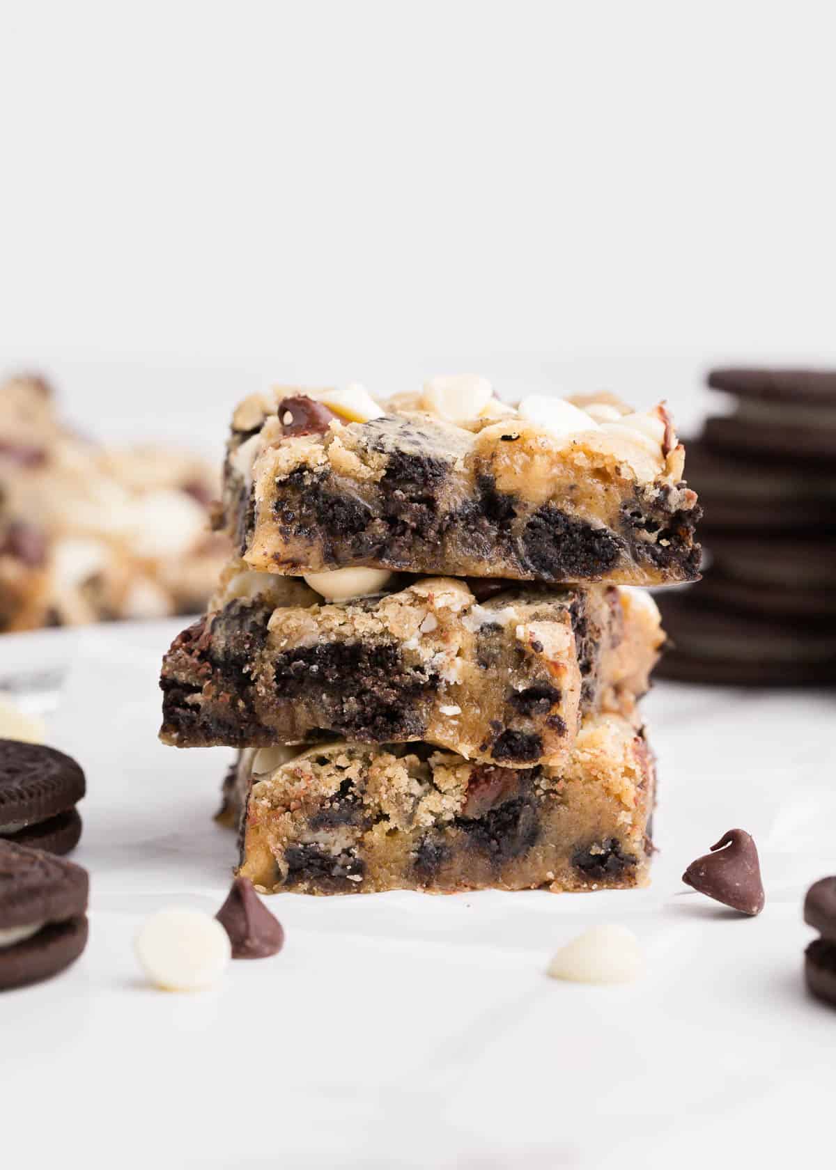 Stacked oreo cookie bars on counter.