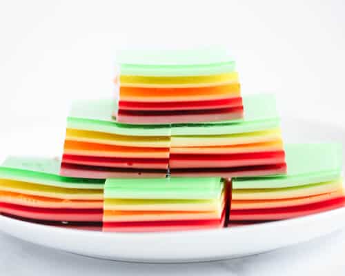 stack of jello rainbow on white plate