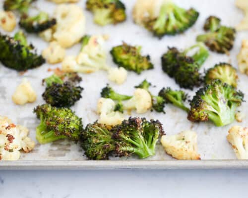 roasted broccoli and cauliflower on baking sheet