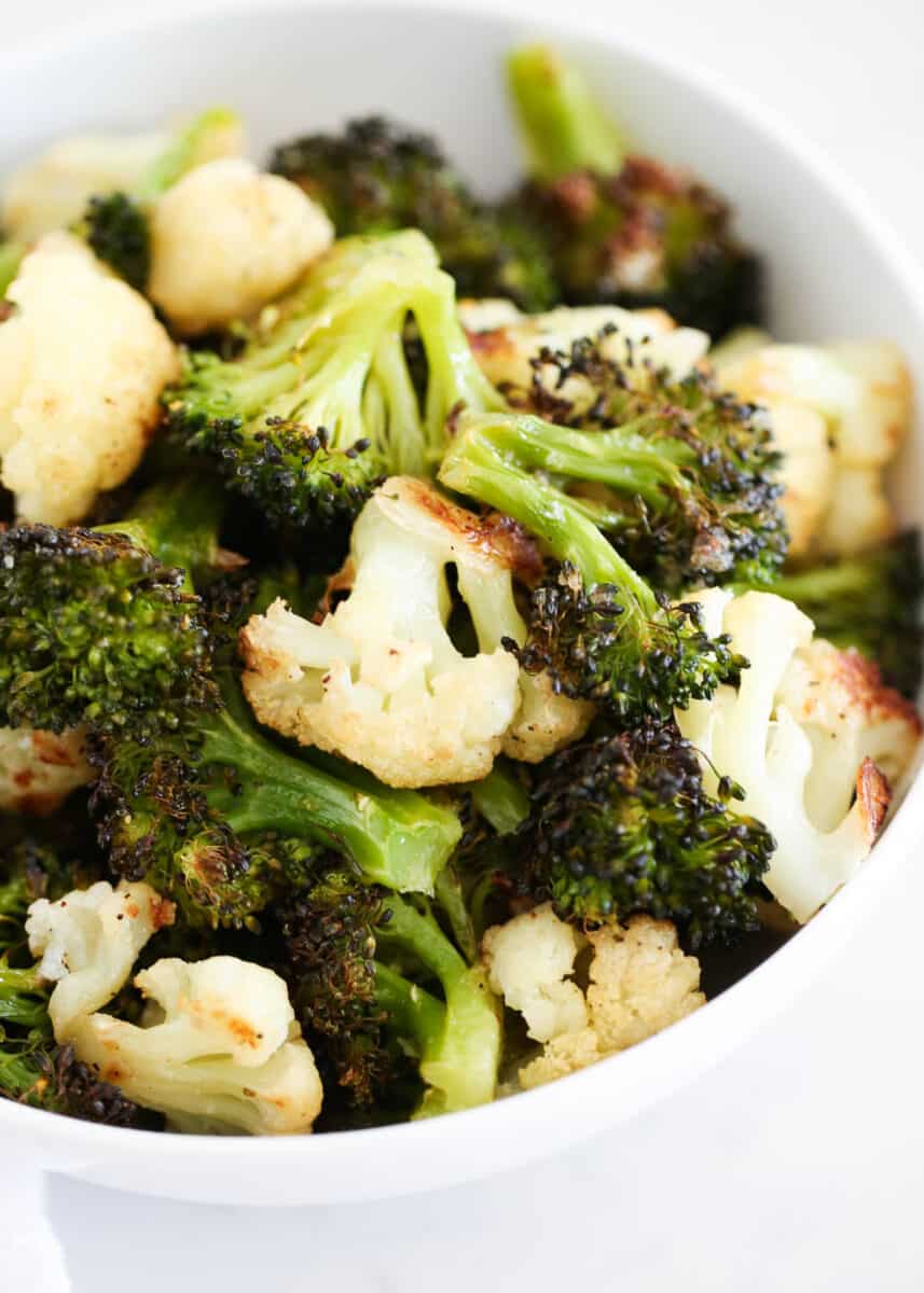 roasted broccoli and cauliflower in a white bowl