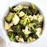 roasted broccoli and cauliflower in a white bowl