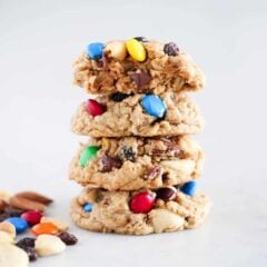 Stack of trail mix cookies with sweet and salty nuts and M&Ms.