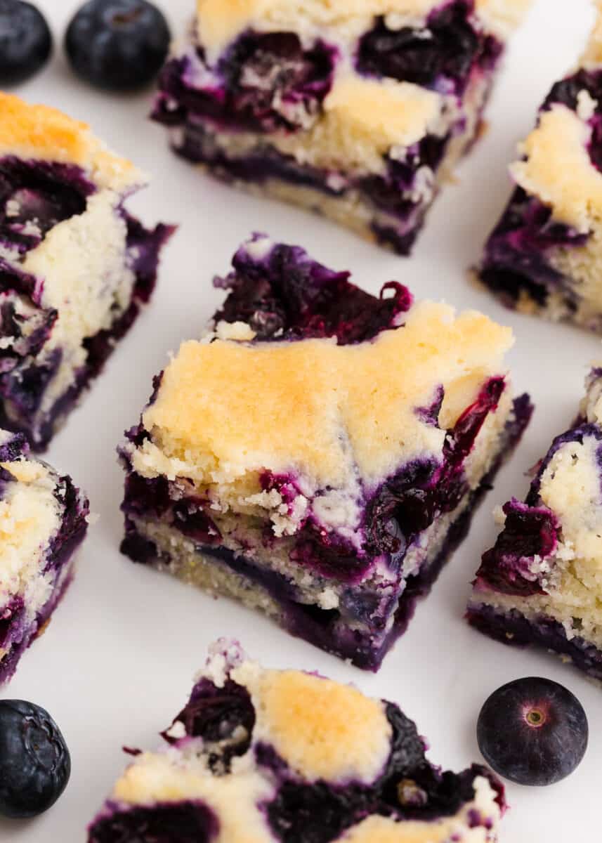 Sliced blueberry buttermilk cake on counter.