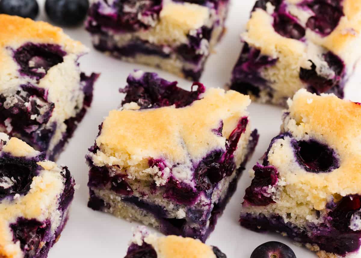 Sliced blueberry buttermilk cake on counter.