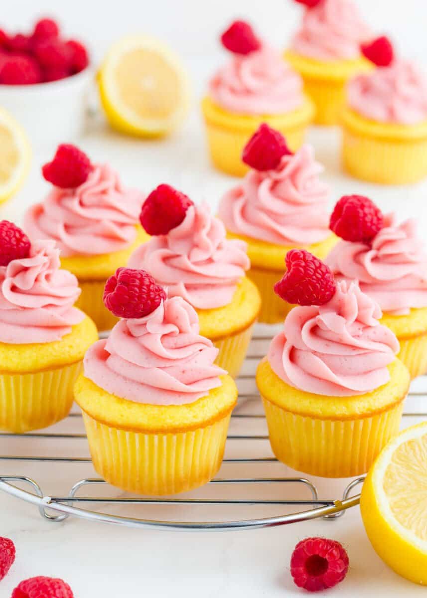 Lemon raspberry cupcakes on cooling rack.