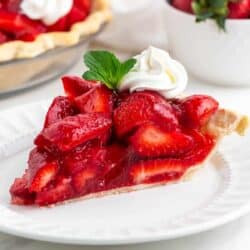 Slice of fresh strawberry pie on a white plate.