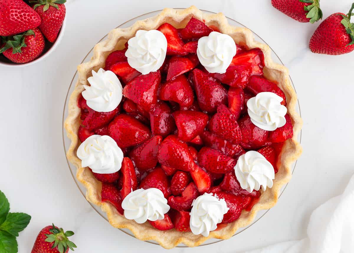 Fresh strawberry pie on a marble countertop.