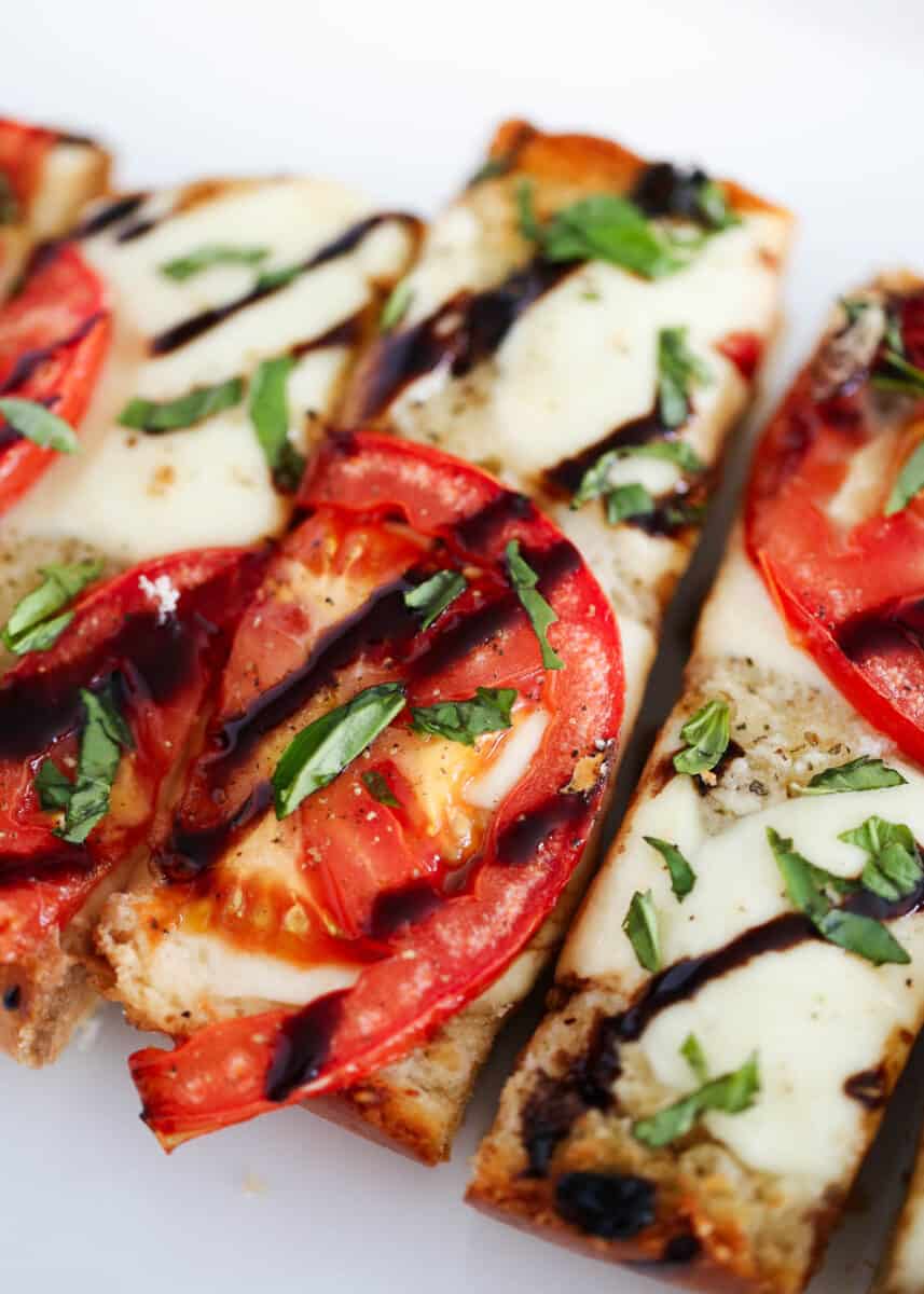 Slice of caprese bread drizzled with balsamic glaze.