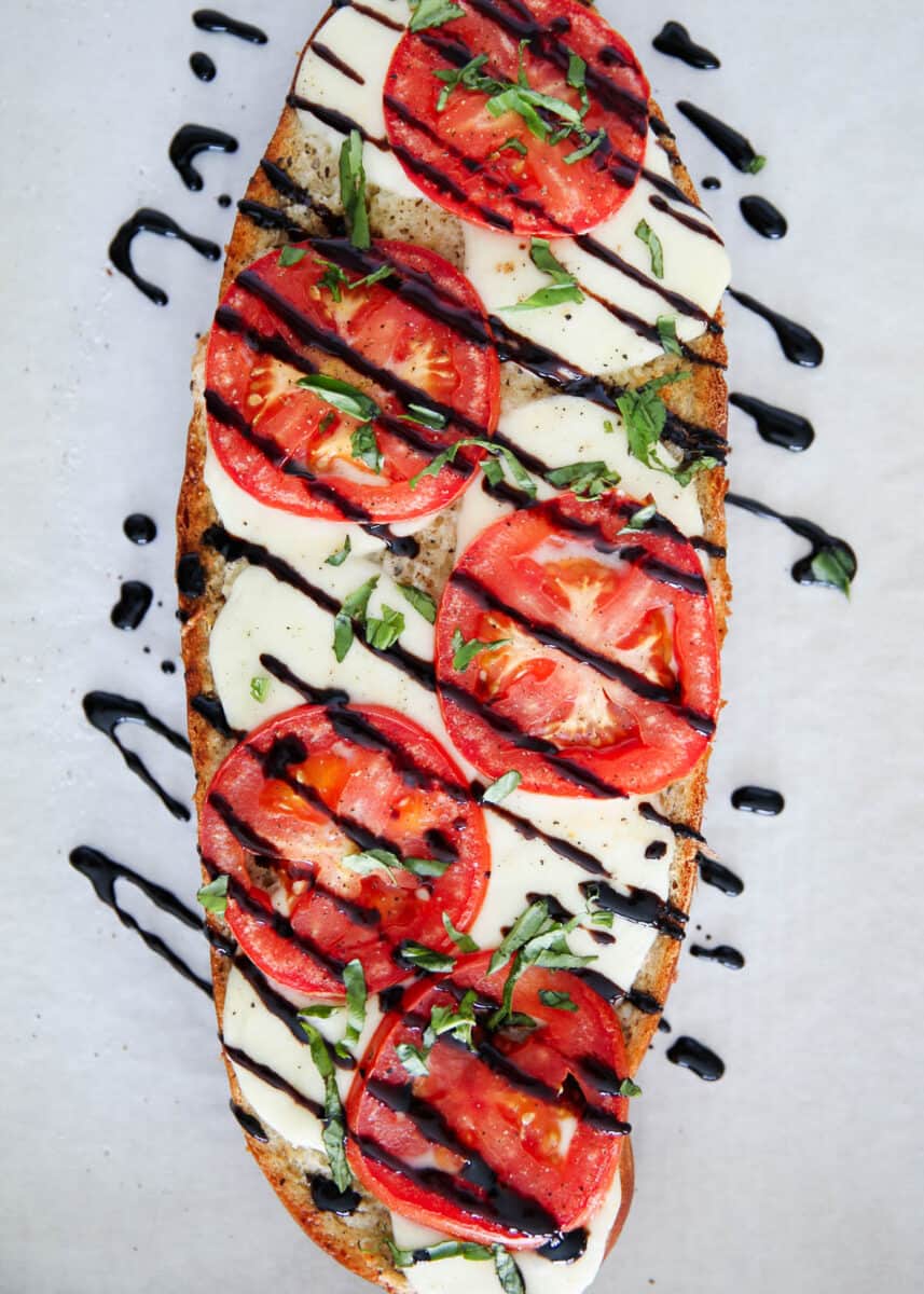 Caprese bread drizzled with balsamic glaze.