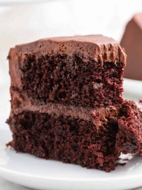 Slice of chocolate cake with a bite taken.