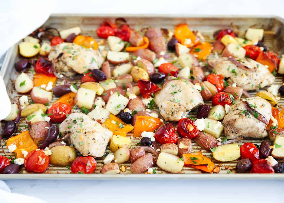 Greek chicken and vegetables cooked on sheet pan.