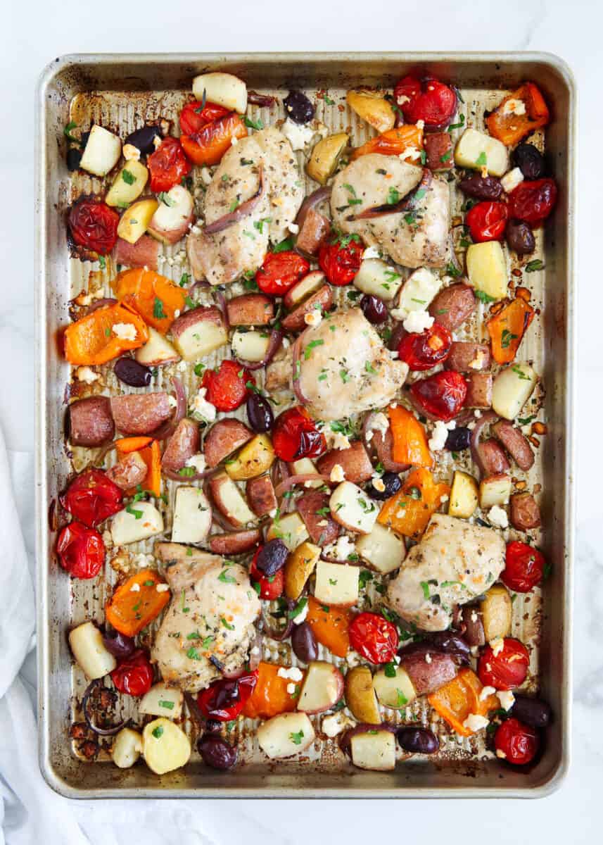 Greek chicken and vegetables cooked on sheet pan.