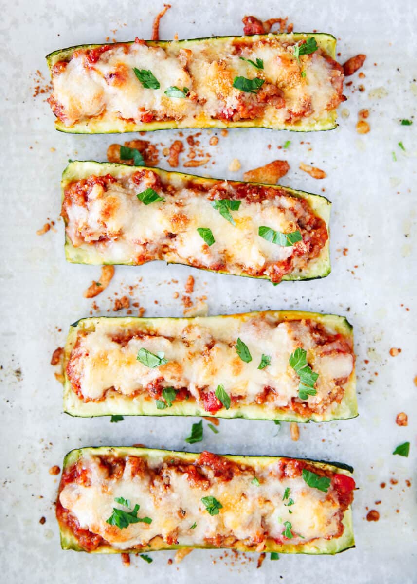 Cooked zucchini boats on a pan.