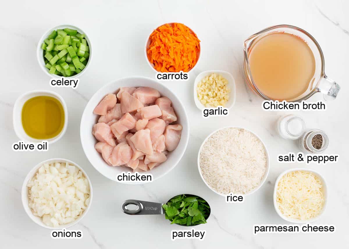 Chicken and rice ingredients on a marble countertop.