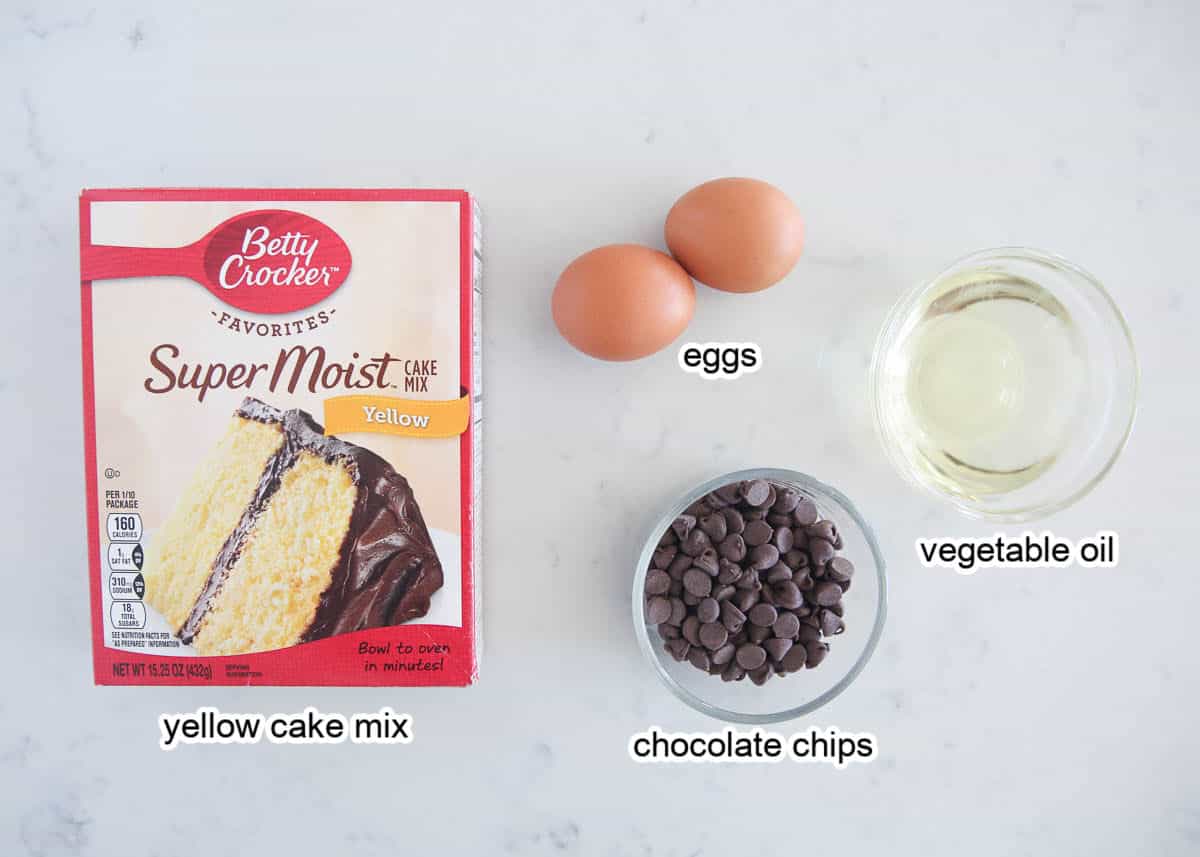 Cake mix chocolate chip cookies are chewy and delicious, and take quick and easy cookie recipes to another level using just a boxed mix, oil, eggs, and loads of chocolate chips! Cake mix cookie ingredients on countertop.