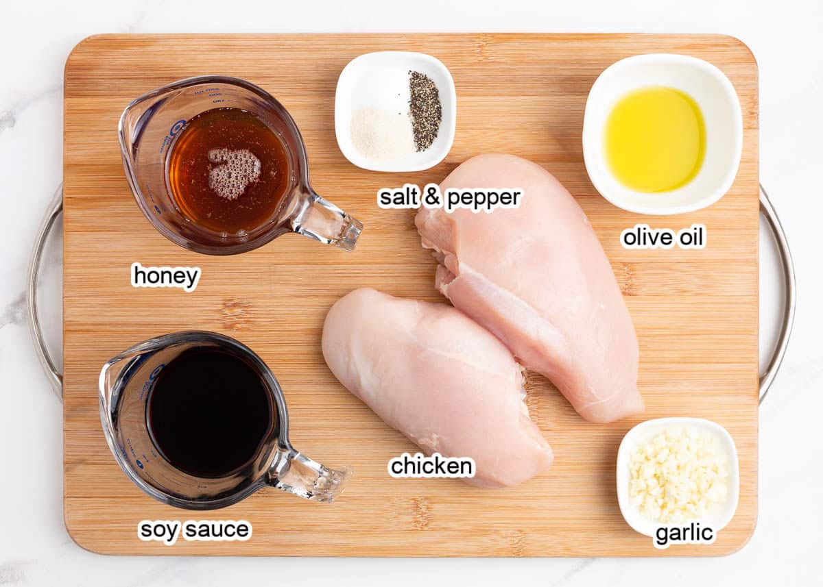 Honey chicken ingredients on a wooden cutting board.