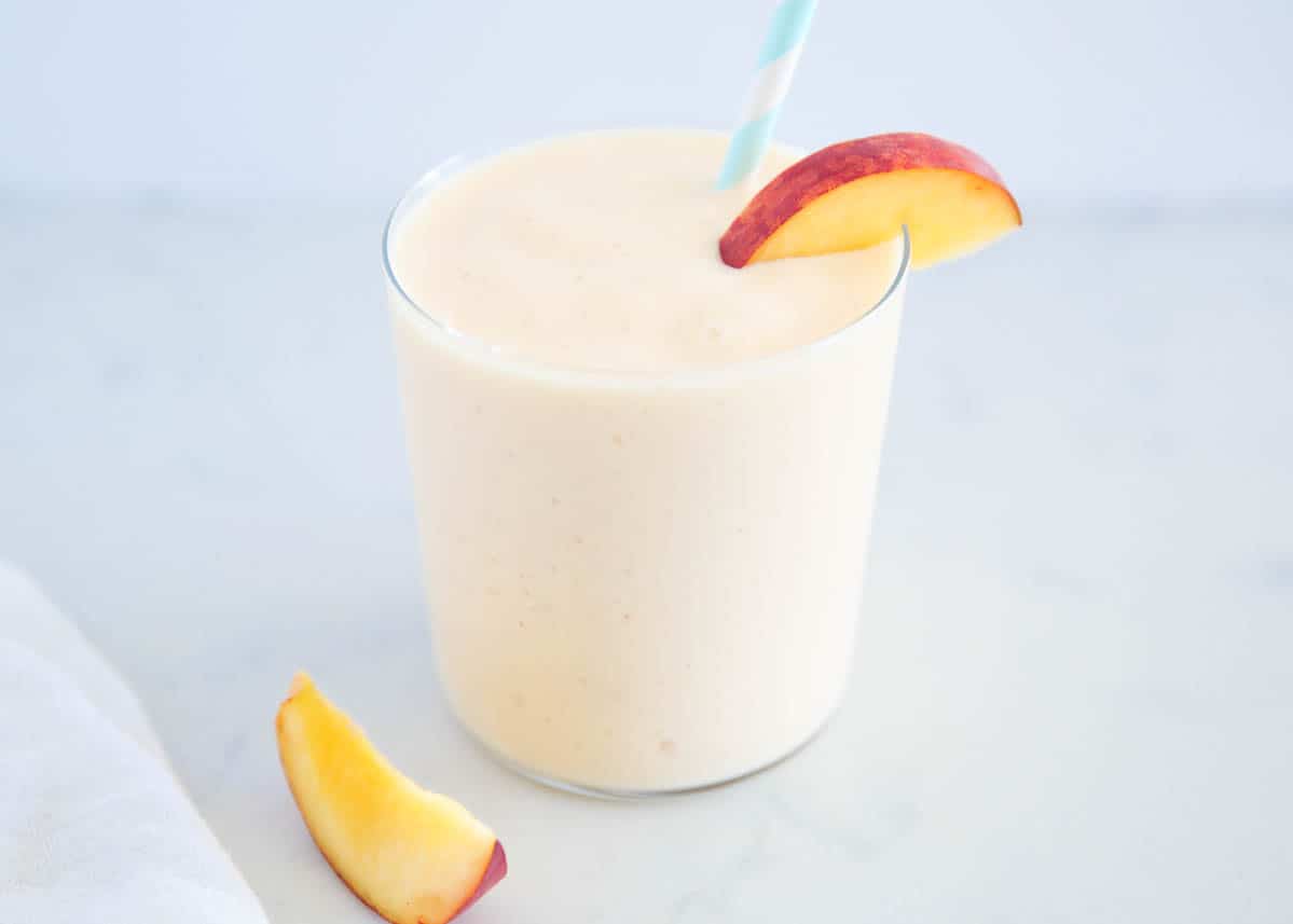 Peach smoothie on marble countertop.