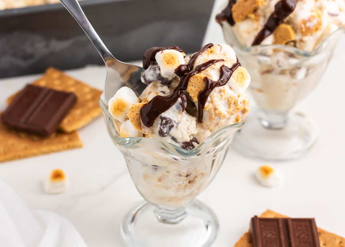 S'mores ice cream in a glass cup with marshmallows and chocolate on top.