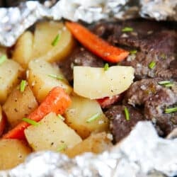 Close up of steak and potatoes in foil.