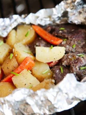Close up of steak and potatoes in foil.