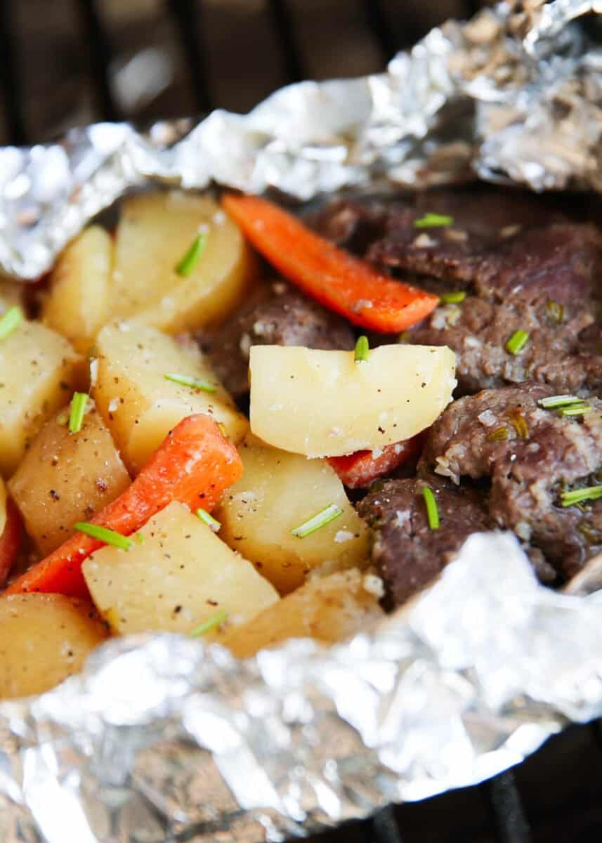 Close up of steak and potatoes in foil.