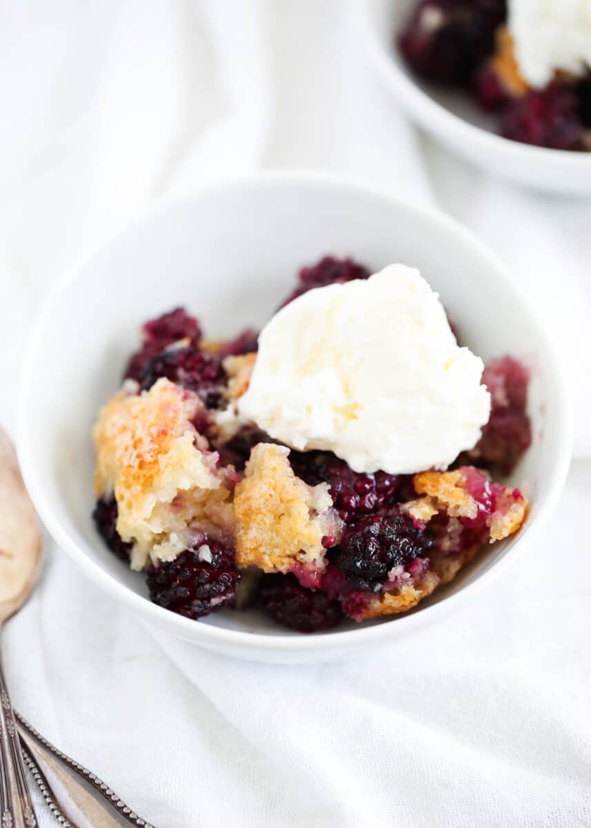Blackberry cobbler and ice cream in a bowl.