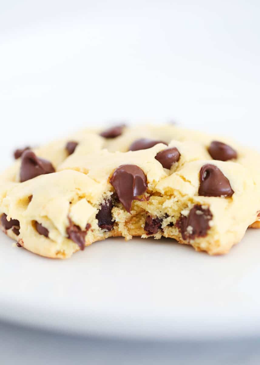 Cake mix chocolate chip cookies are chewy and delicious, and take quick and easy cookie recipes to another level using just a boxed mix, oil, eggs, and loads of chocolate chips! Bite taken from chocolate chip cookie.