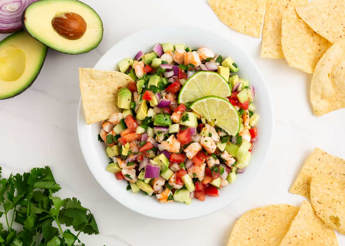 Ceviche in white bowl on marble countertop.