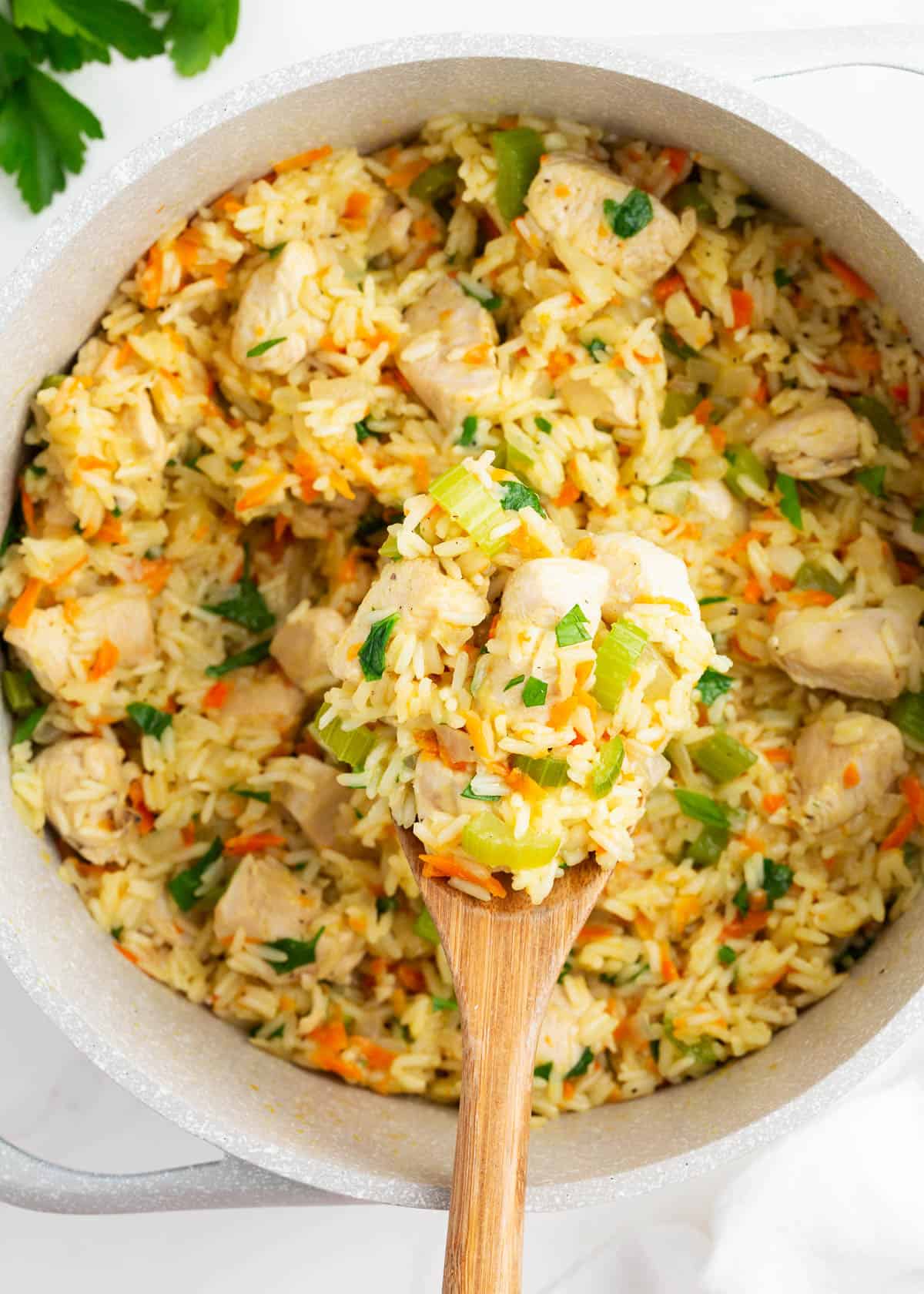 Chicken and rice in a pot with spoon.