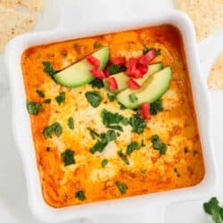 Chicken enchilada dip in white baking dish.