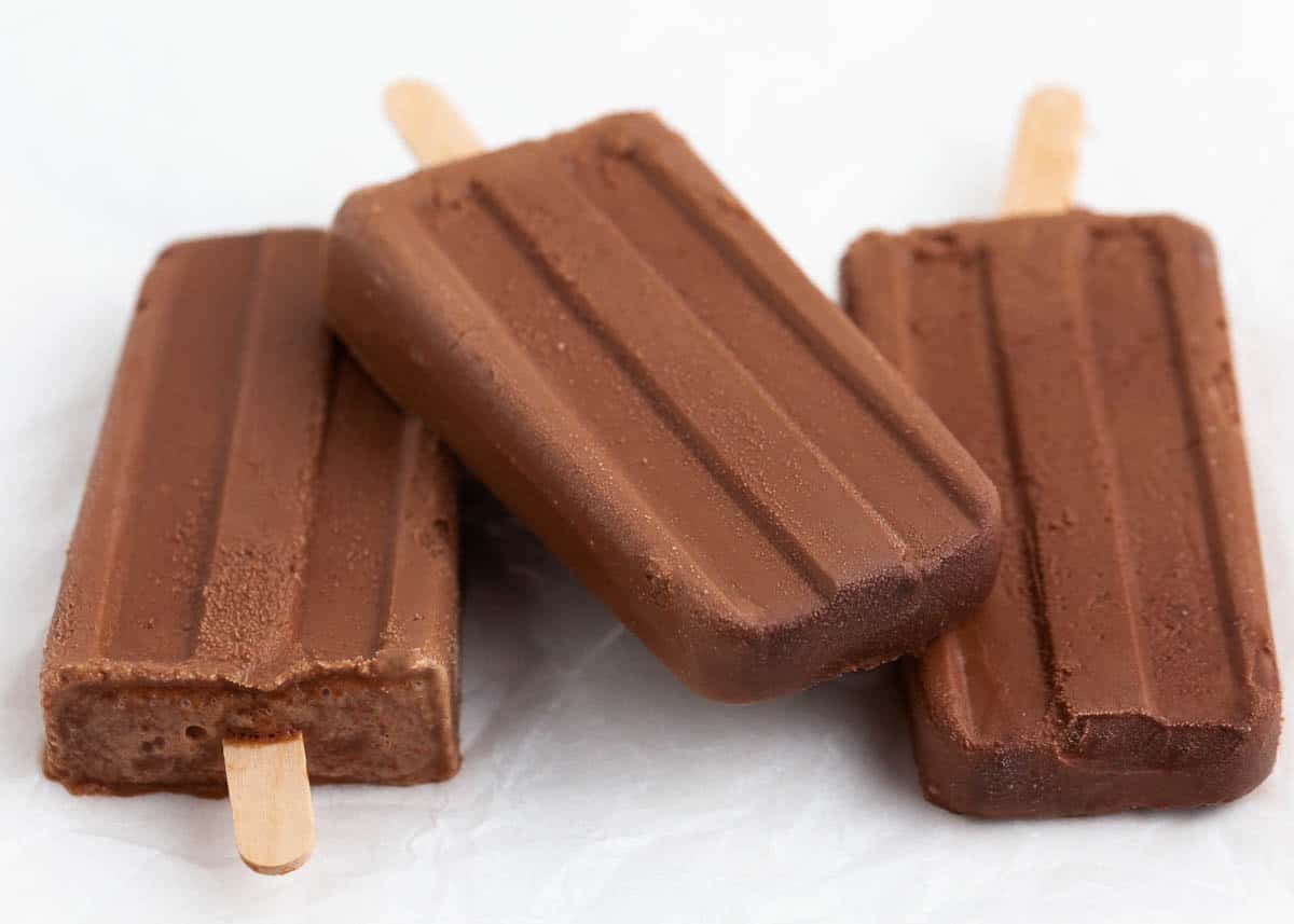 Fudge popsicles stacked on the countertop.