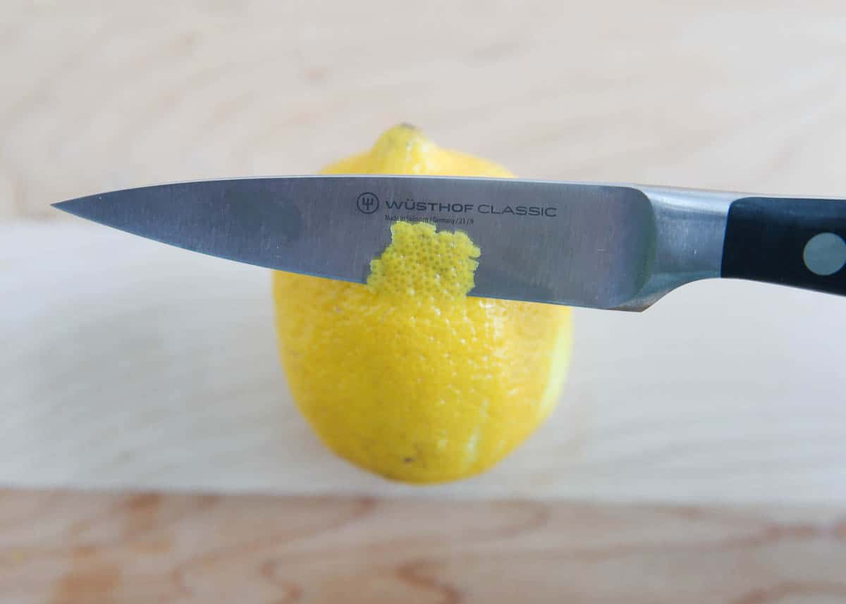 Cutting a lemon with a knife.
