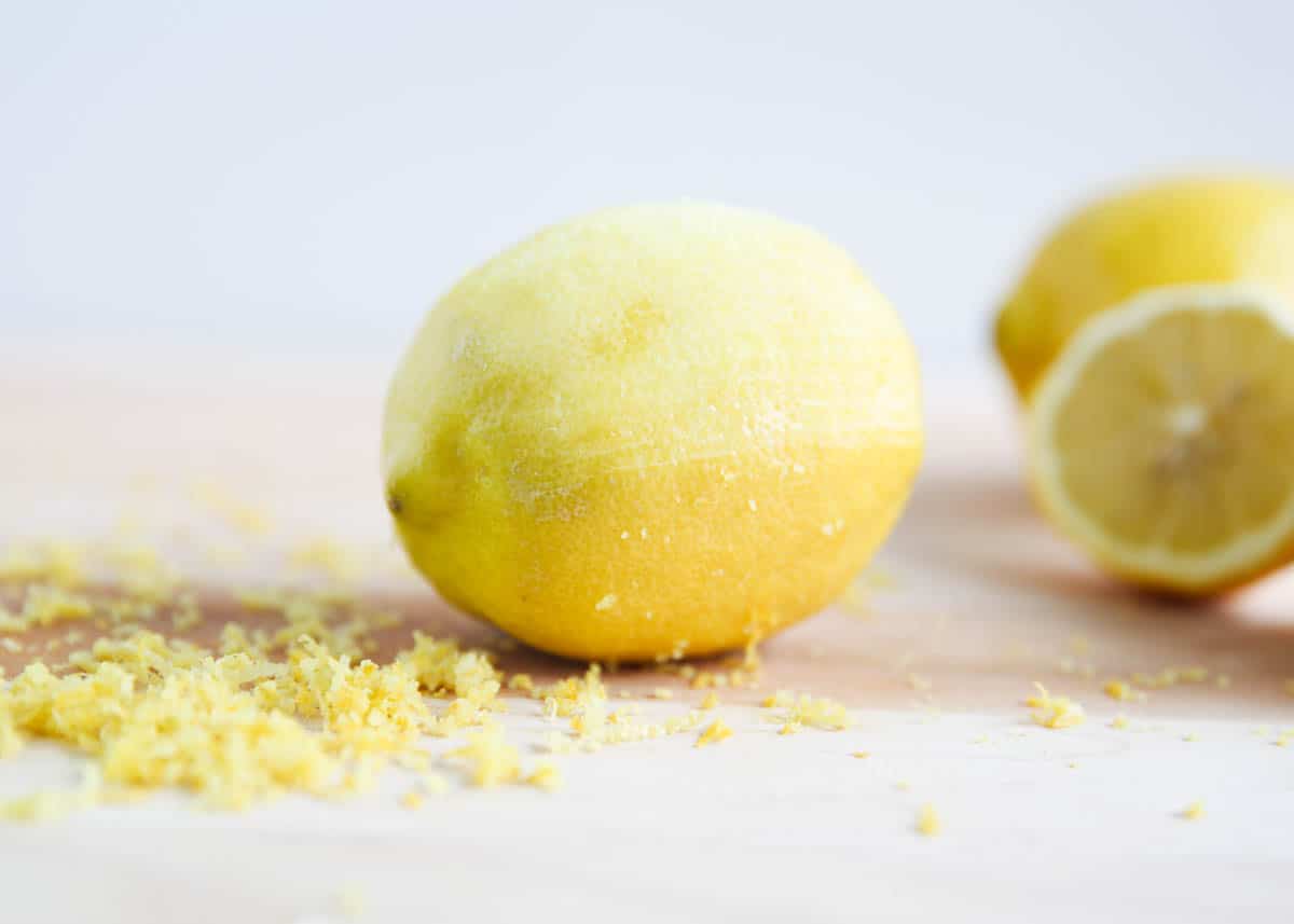 A lemon zested on a cutting board.