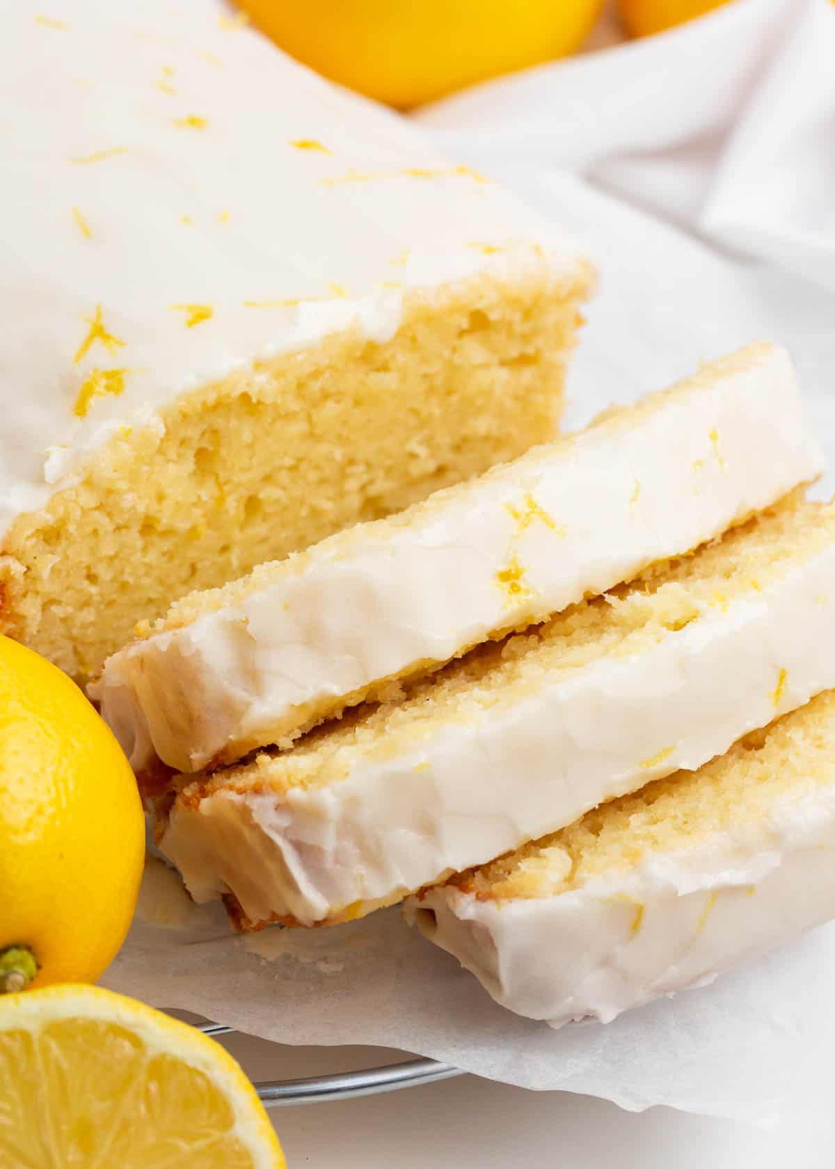 Sliced lemon loaf with lemon glaze.