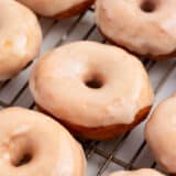 Maple glaze donuts on a cooling rack.